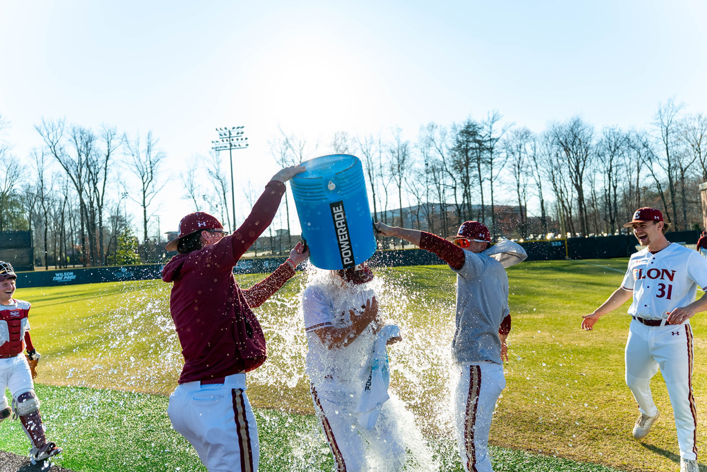 This photo provided by Elon University shows Elon baseball players dumping water on pitcher Aidan Stieglitz (42) after winning a NCAA college baseball game against Charleston Southern, Saturday, Feb. 28, 2026, in Elon, N.C. (Matthew Lewyn/Elon University via AP)