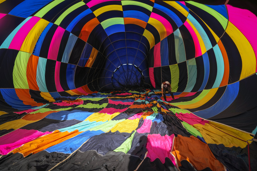 A hot air balloon is inflated for a practice run, a day ahead of the World Ballooning Championships in Colonia Yguazu, Paraguay, Aug. 28, 2025. (AP Photo/Jorge Saenz)
