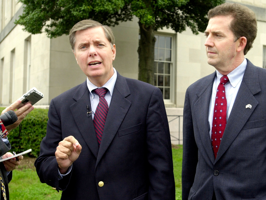 FILE - Sen. Lindsey Graham, R-S.C., speaks to the press about the appointment of federal judges during a news conference with Senate candidate Rep. Jim DeMint, right, at the Federal courthouse in Greenville, S.C., Oct. 21, 2004. (AP Photo/Mary Ann Chastain, File)