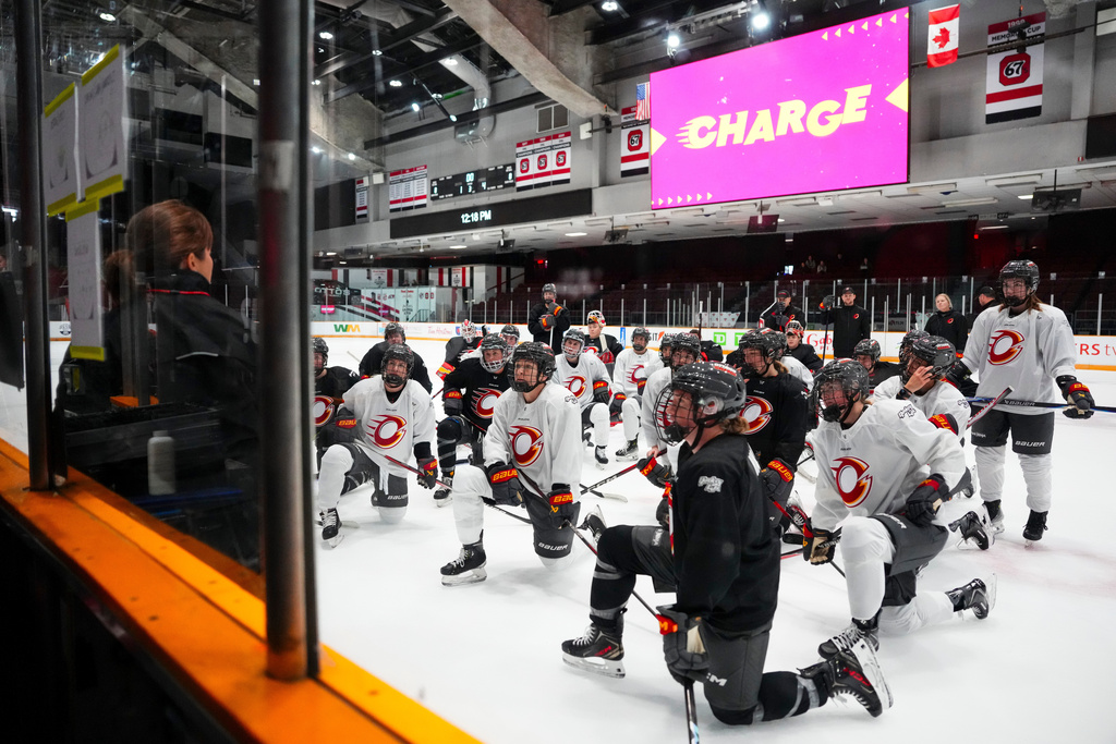 Ottawa Charge head coach Carla MacLeod, left, speaks to her team during PWHL hockey training camp, Wednesday, Nov. 12, 2025, in Ottawa, Ontario (Sean Kilpatrick/The Canadian Press via AP)