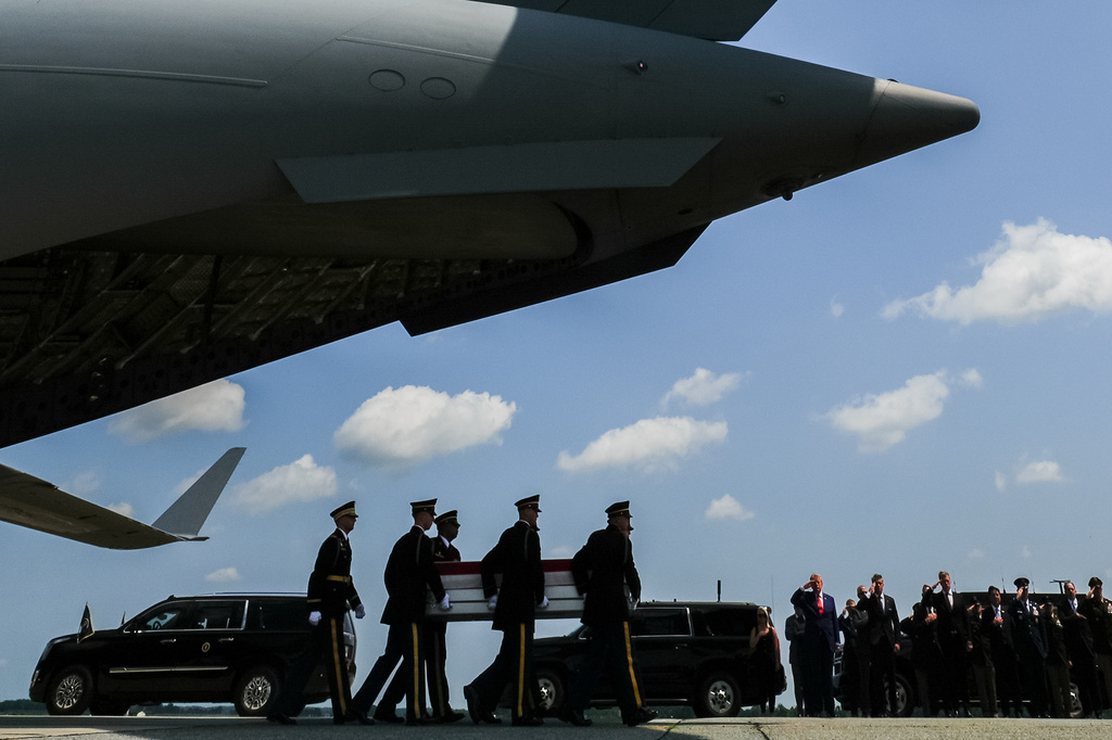 President Donald Trump and others salute as a U.S. Army carry team moves a transfer case containing the remains of 1st Lt. Tyler James Feehan, of Ewa Beach, Hawaii, Wednesday, July 22, 2026, at Dover Air Force Base, Del. (AP Photo/Julia Demaree Nikhinson)