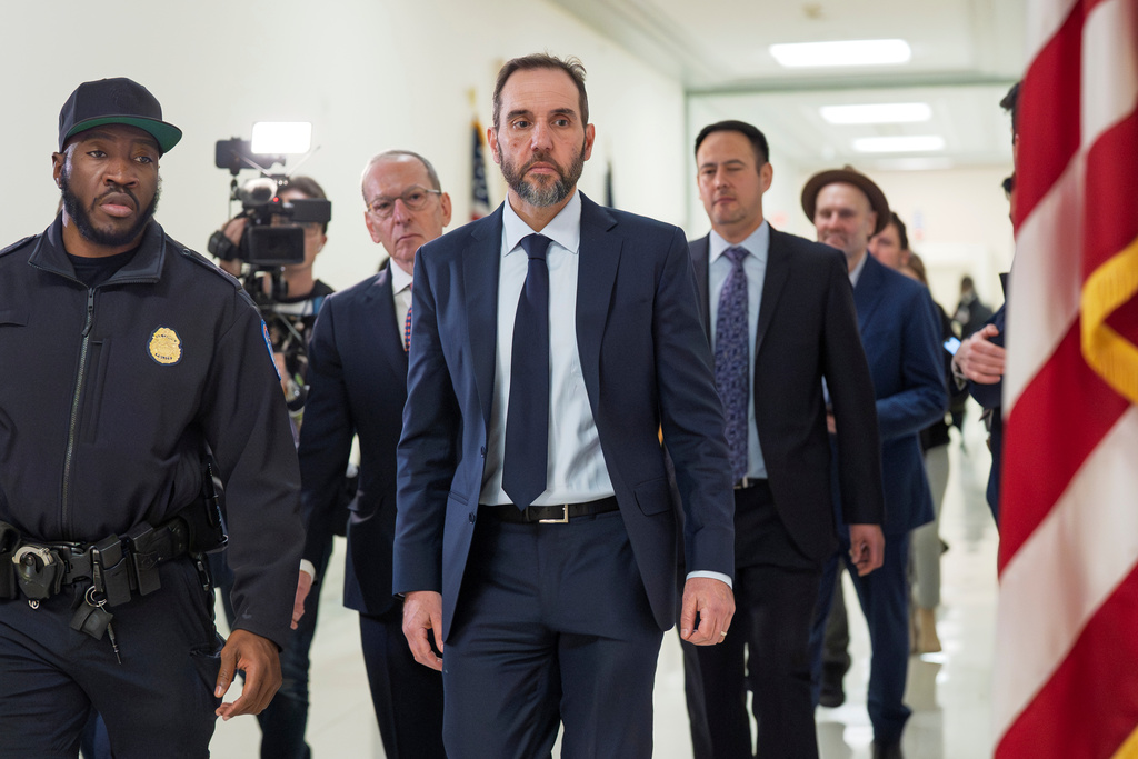 Former Department of Justice Special Counsel Jack Smith, center, and his attorney Lanny Breuer, center rear, arrive at a hearing room in the Rayburn House Office Building after a break in his deposition before the House Judiciary Committee, part of its oversight into DOJ investigations into President Donald Trump, on Capitol Hill in Washington, Wednesday, Dec. 17, 2025. (AP Photo/J. Scott Applewhite)