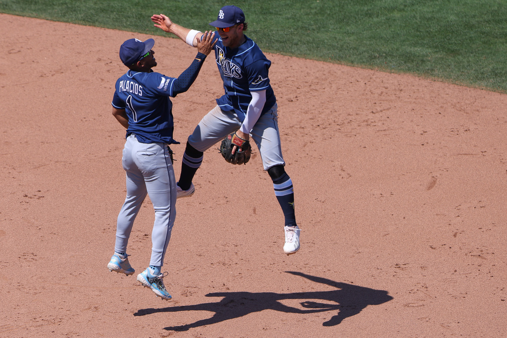 Tampa Bay Rays' Richie Palacios (1) and Taylor Walls, right, celebrate after the final out of a baseball game as the Rays defeat the Athletics Wednesday, Aug. 12, 2026, in West Sacramento, Calif. (AP Photo/Scott Marshall)