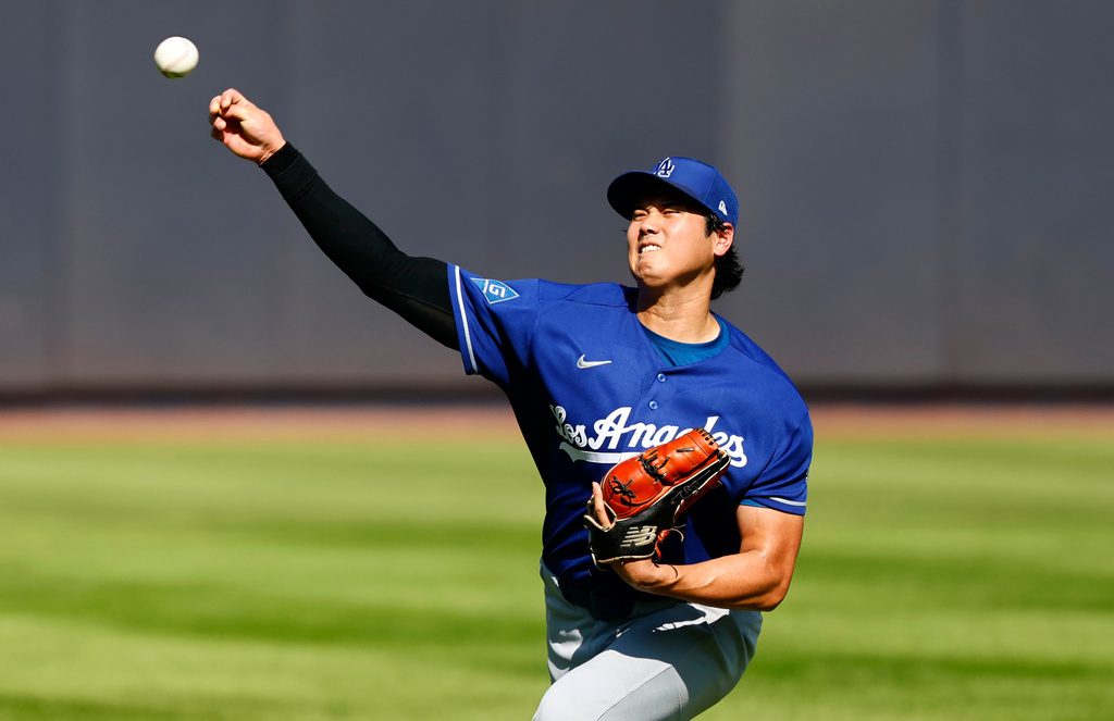 Los Angeles Dodgers' Shohei Ohtani throws in the outfield before the second game of a baseball doubleheader against the New York Yankees, Sunday, July 19, 2026, in New York. (AP Photo/Noah K. Murray)