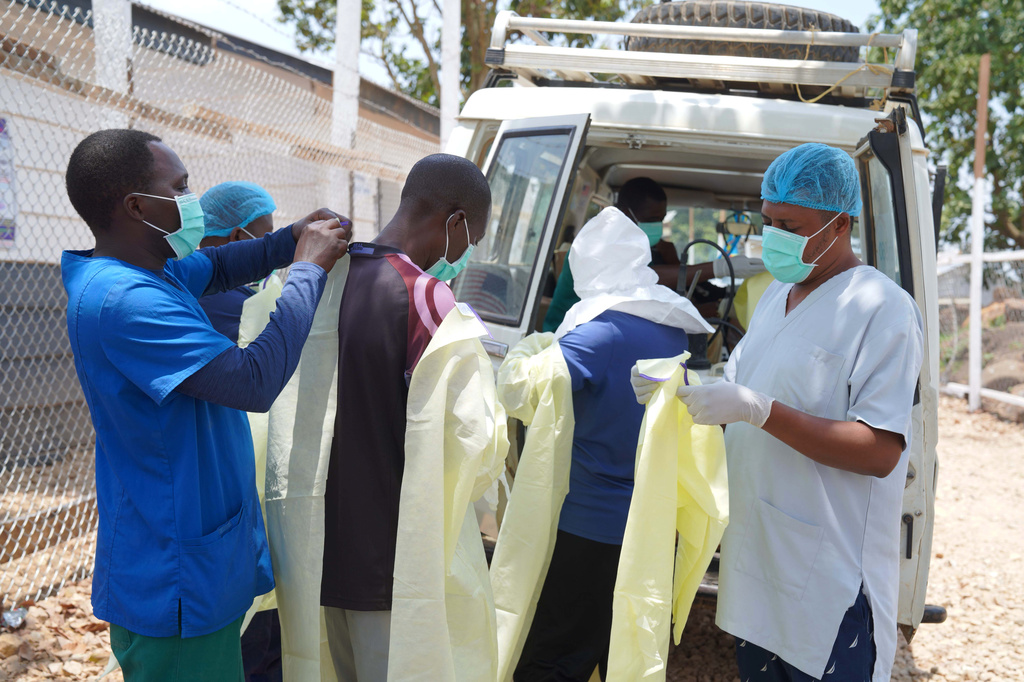 Health workers who are members of the safe and dignified burial team prepare to bury Abineno Justine, a 38 year old woman who died of the Ebola virus, in Bunia, Congo, Friday, Sept. 4, 2026. (AP Photo/Dieudonne Dirole)
