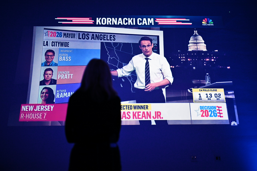 An attendee monitors results at an election night event for Los Angeles Mayor Karen Bass on Tuesday, June 2, 2026, in Los Angeles. (AP Photo/William Liang)