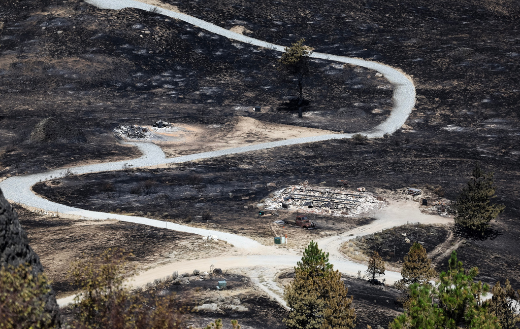 Debris from a burnt house is scattered after the Chelan Hills Fire burned through McNeil Canyon on Wednesday, July 8, 2026, in Orondo, Wash. (Nick Wagner/The Seattle Times via AP)