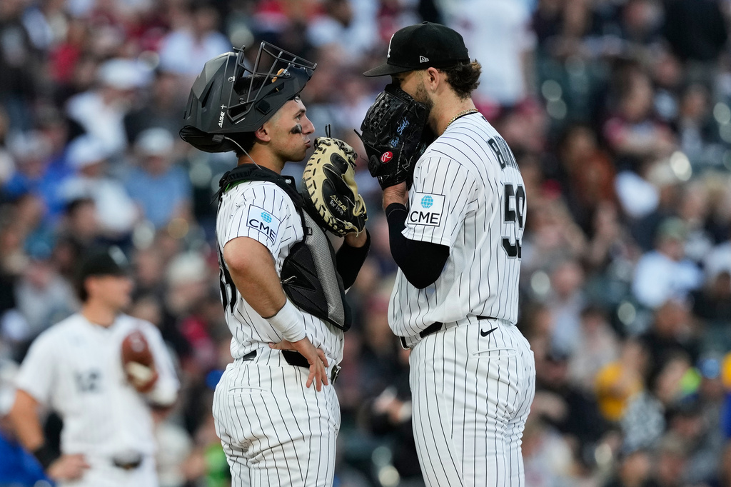 Chicago White Sox catcher Drew Romo, left, talks with starting pitcher Sean Burke during the fifth inning of a baseball game against the Cleveland Guardians in Chicago, Tuesday, June 23, 2026. (AP Photo/Nam Y. Huh)
