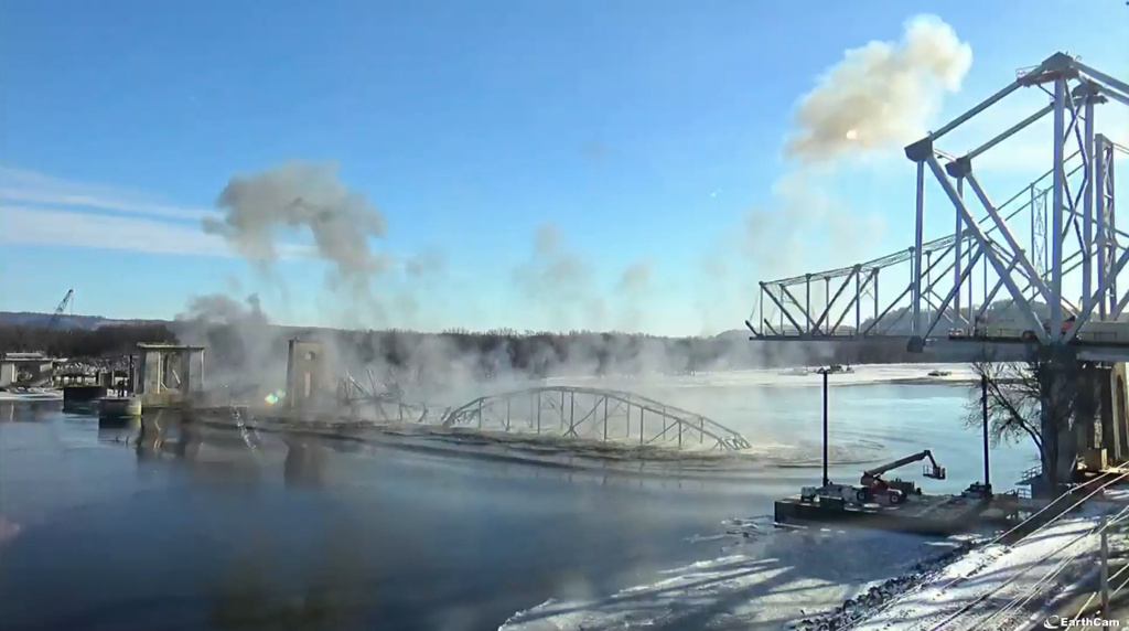This image provided by Iowa Department of Transportation shows the implosion of the 94-year-old Black Hawk Bridge over the Mississippi River between Iowa and Wisconsin on Friday, Dec. 19, 2025. (Iowa Department of Transportation via AP)