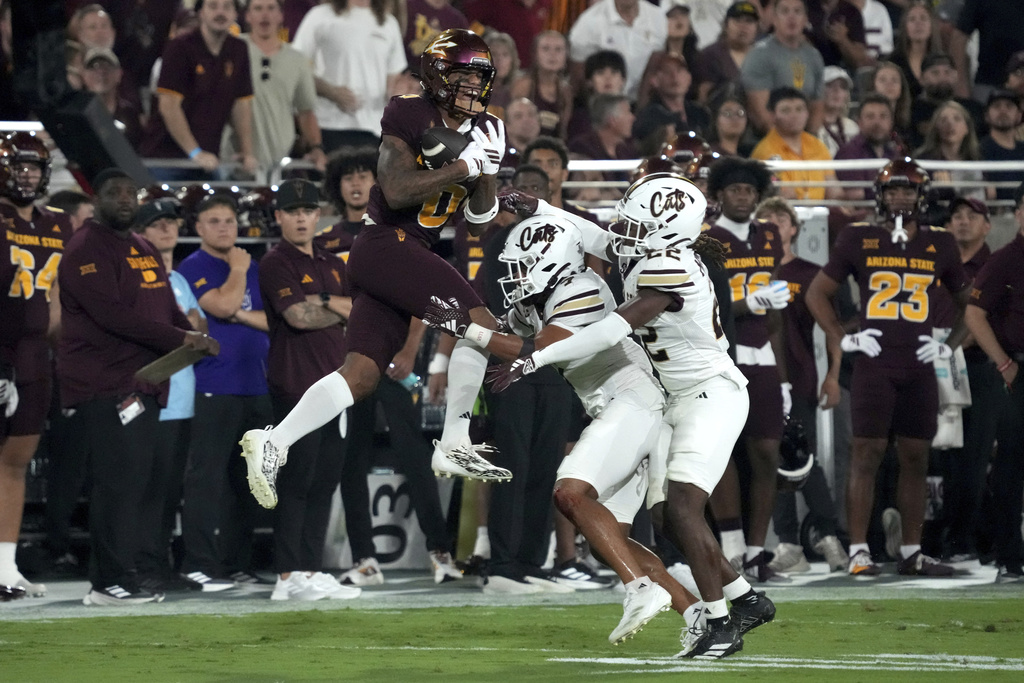 Arizona State wide receiver Jordyn Tyson (0) makes the catch over Texas State safety Ryan Nolan and safety Will Mitchell II (22) in the first half of an NCAA college football game, Saturday, Sept. 13, 2025, in Tempe, Ariz. (AP Photo/Rick Scuteri)
