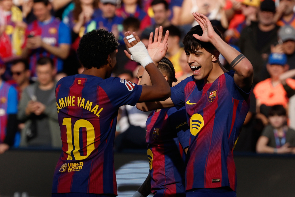 Barcelona's Lamine Yamal, left, and Marc Bernal celebrate after a goal during a La Liga soccer match between Barcelona and Levante in Barcelona, Spain, Sunday, Feb. 22, 2026. (AP Photo/Joan Monfort)