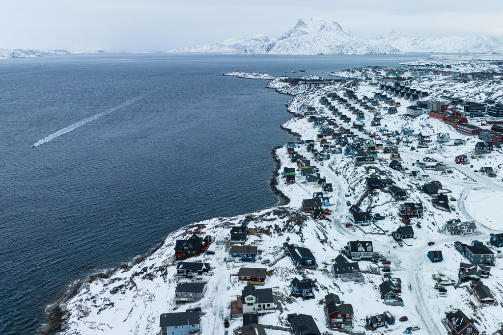 Houses are seen near the coast of a sea inlet of Nuuk, Greenland, on Saturday, Jan. 24, 2026. (AP Photo/Evgeniy Maloletka)