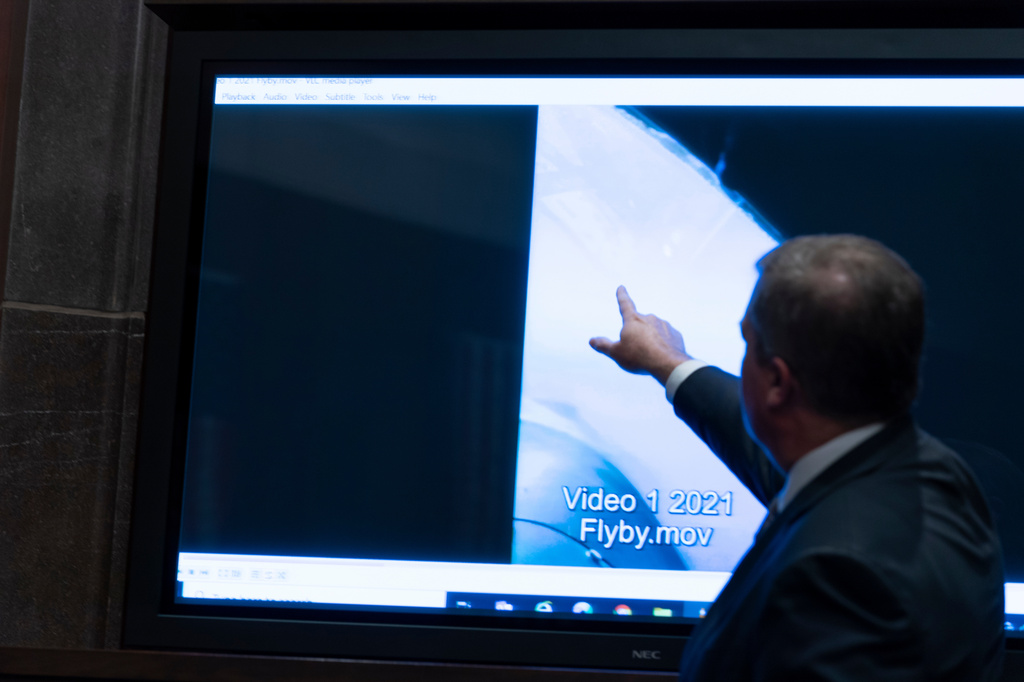 FILE - Deputy Director of Naval Intelligence Scott Bray points to a video display of a UAP during a hearing of the House Intelligence, Counterterrorism, Counterintelligence, and Counterproliferation Subcommittee hearing on "Unidentified Aerial Phenomena," on Capitol Hill, May 17, 2022, in Washington. (AP Photo/Alex Brandon, File)