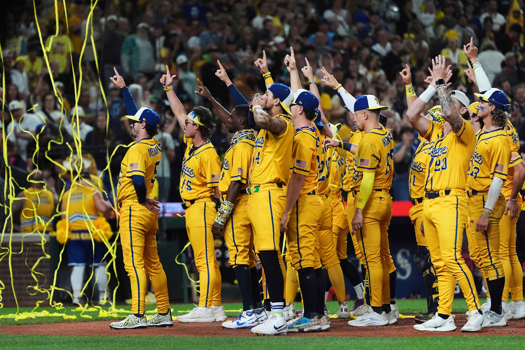 FILE - The Savannah Bananas celebrate their win over the Firefighters during their "Banana Ball World Tour" on Sept. 19, 2025, in Seattle. (AP Photo/Lindsey Wasson, File)