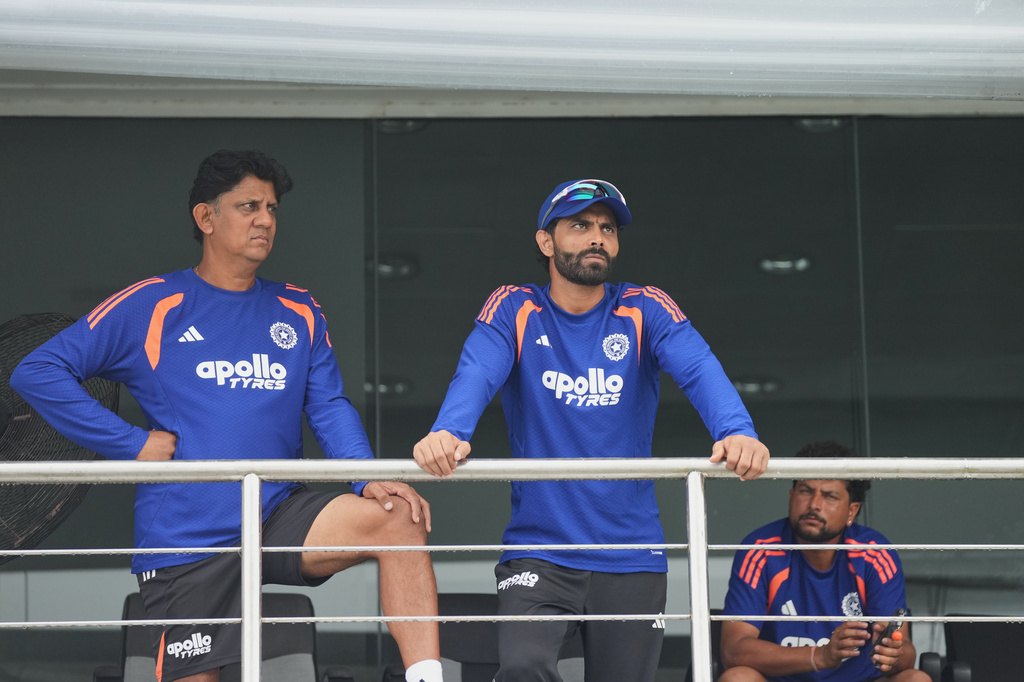 India's Ravindra Jadeja, right, and a team official wait in the team dressing room as play is delayed due to rain during the second day of the first Test cricket match between Sri Lanka and India in Galle, Sri Lanka, Sunday, Aug. 16, 2026. (AP Photo/Eranga Jayawardena)