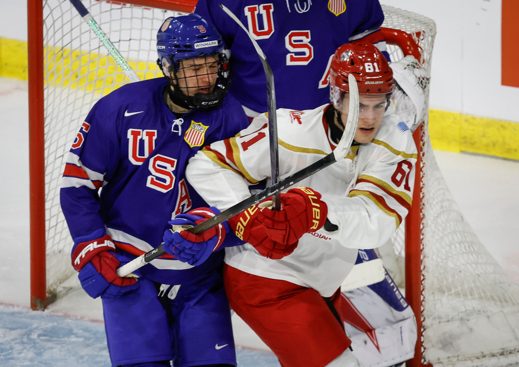 Team USA's JJ Marthaler, left, and Team CHL's Ethan Belchetz battle for position during second period CHL-USA Prospects Challenge hockey action in Lethbridge, Alberta, on Wednesday, Nov. 26, 2025. (Jeff McIntosh/The Canadian Press via AP)