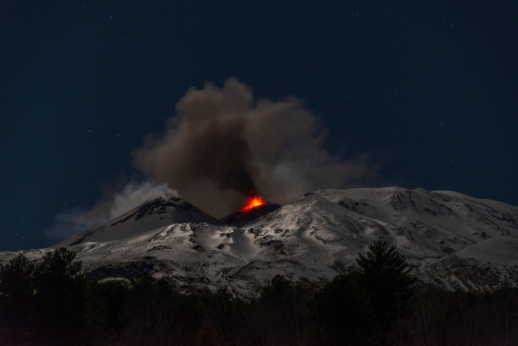 Explosive activity concentrates at the north-east crater of the Mount Etna, as an eruption started on Dec. 24 continues, in Sicily, Italy, Monday Dec. 29, 2025. (AP Photo/Salvatore Allegra)