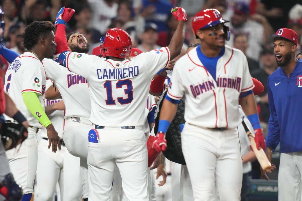 Dominican Republic's Junior Caminero (13) celebrates his home run during the second inning of a World Baseball Classic semifinal game against the United States, Sunday, March 15, 2026, in Miami. (AP Photo/Lynne Sladky)