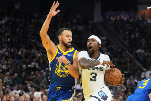 Memphis Grizzlies guard Kentavious Caldwell-Pope, right, drives to the basket against Golden State Warriors guard Stephen Curry during the first half of an NBA basketball game in San Francisco, Monday, Oct. 27, 2025. (AP Photo/Jeff Chiu) Memphis Grizzlies guard Kentavious Caldwell-Pope, right, drives to the basket against Golden State Warriors guard Stephen Curry during the first half of an NBA basketball game in San Francisco, Monday, Oct. 27, 2025. (AP Photo/Jeff Chiu)