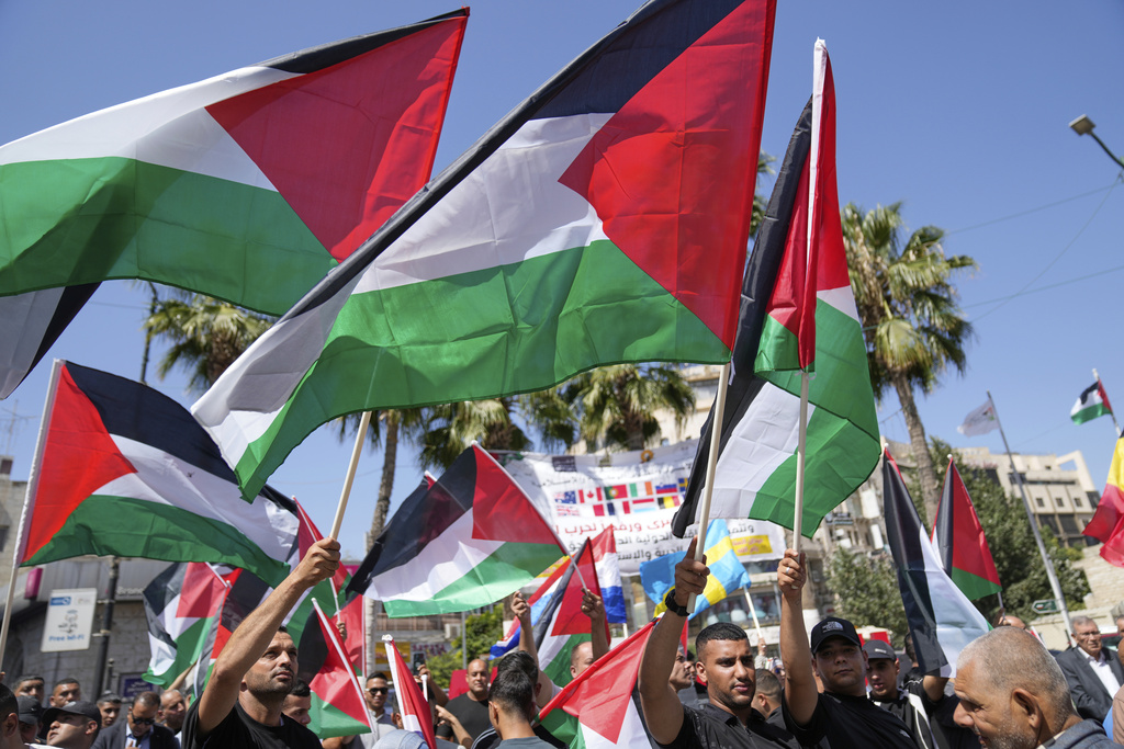 Palestinians fly their flags during a rally in support for Gaza and celebrating the latest western nations recognitions of the Palestinian state ahead of the United Nations General Assembly meetings, in the West Bank city of Ramallah Tuesday, Sept. 23, 2025. (AP Photo/Nasser Nasser)