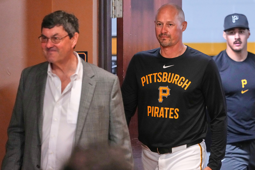 Pittsburgh Pirates' Konnor Griffin, right, follows manager Don Kelly, center, and owner Bob Nutting into a meeting with reporters before making his Major League Baseball debut in the Pirates' home-opener against the Baltimore Orioles, Friday, April 3, 2026, in Pittsburgh. (AP Photo/Gene J. Puskar)