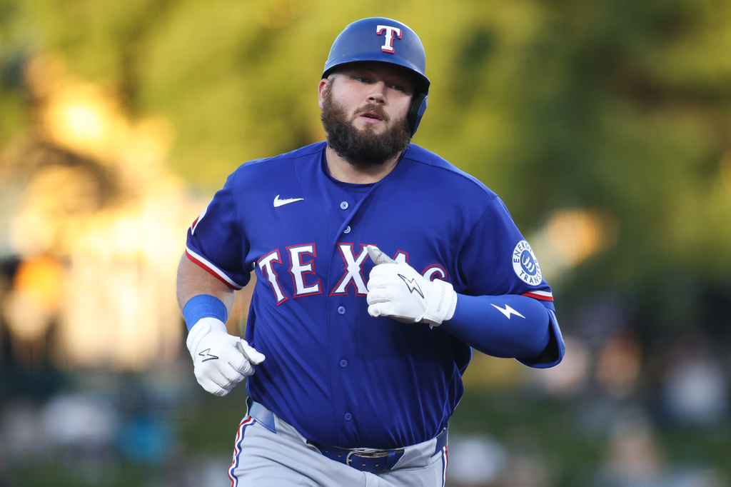 Texas Rangers' Jake Burger jogs around the bases after hitting a solo home run during the third inning of a baseball game against the Athletics, Monday, April 13, 2026, in West Sacramento, Calif. (AP Photo/Scott Marshall)