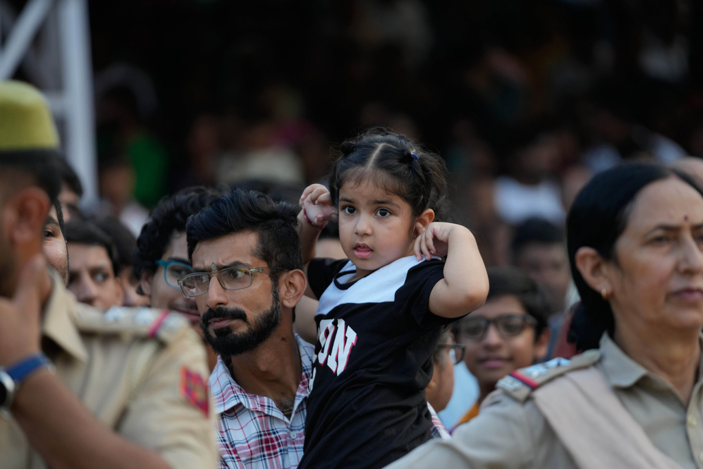 People watch a procession during Dussehra festival in Jammu, India, Thursday, Oct.2, 2025.(AP Photo/Channi Anand)