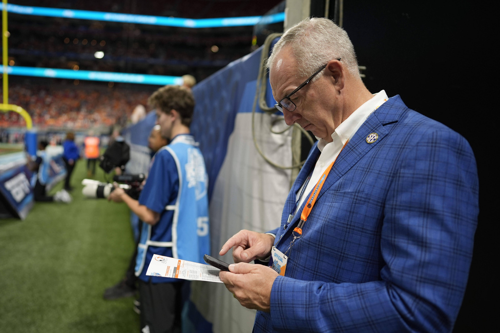 SEC Chairman Greg Sankey stands on the field during the first half an NCAA college football game between Syracuse and Tennessee, Saturday, Aug. 30, 2025, in Atlanta. (AP Photo/Mike Stewart)
