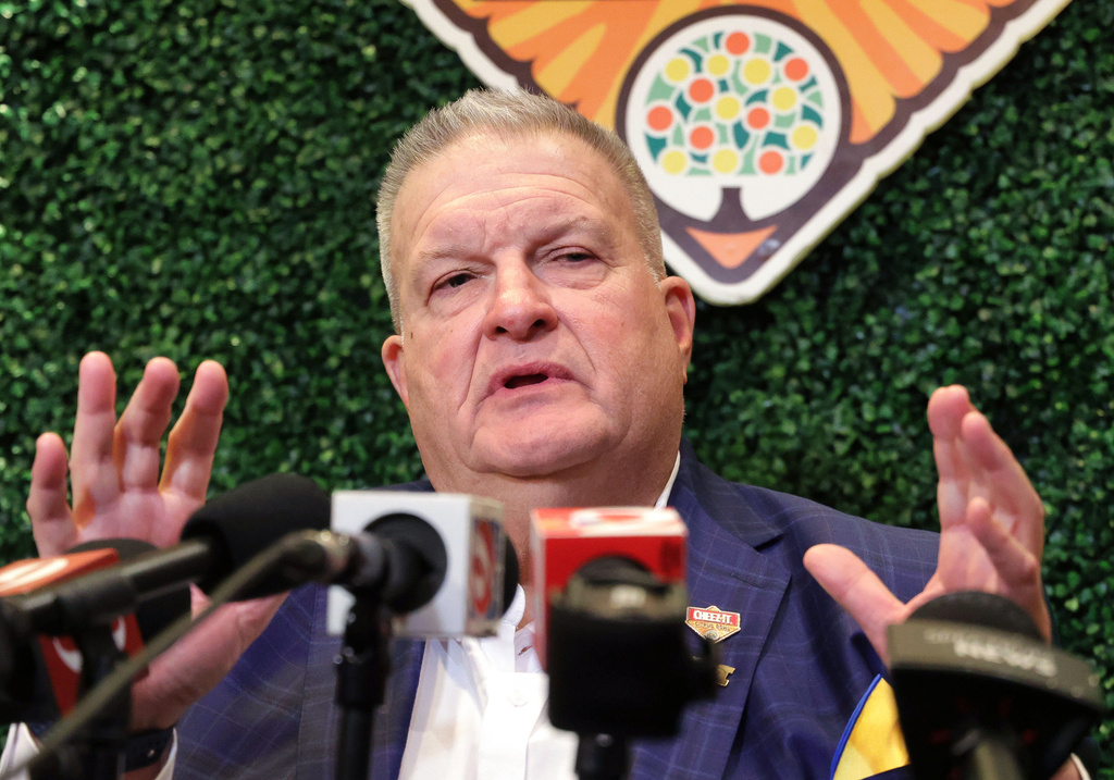Michigan interim head coach Biff Poggi answers a question during an NCAA college football Citrus Bowl news conference in Winter Park, Fla., Monday, Dec. 15, 2025, ahead of his team's New Year's Eve appearance against Texas in the bowl in Orlando, Fla. (Joe Burbank/Orlando Sentinel via AP)
