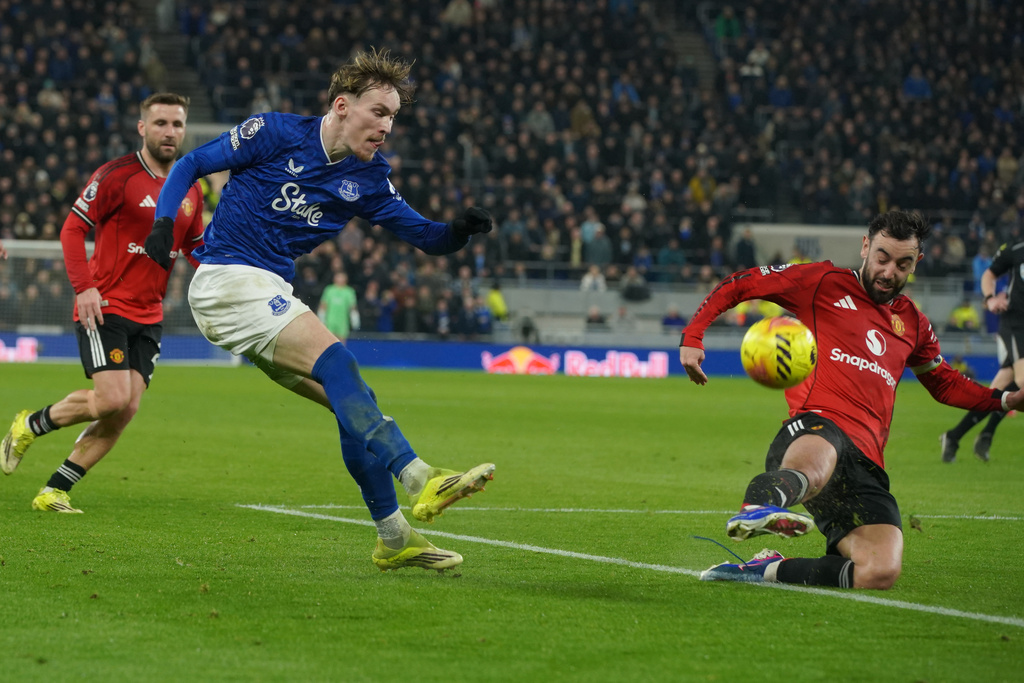 Manchester United's Bruno Fernandes tries to block shot by Everton's James Garner during the Premier League soccer match between Manchester United and Everton in Liverpool, England, Monday, Feb. 23, 2026. (AP Photo/Ian Hodgson)