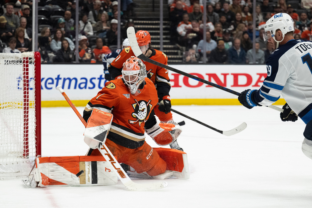 Anaheim Ducks goaltender Lukas Dostal, front left, blocks a shot in front of Winnipeg Jets center Jonathan Toews, right, during the second period of an NHL hockey game, Friday, Feb. 27, 2026, in Anaheim, Calif. (AP Photo/Kyusung Gong)