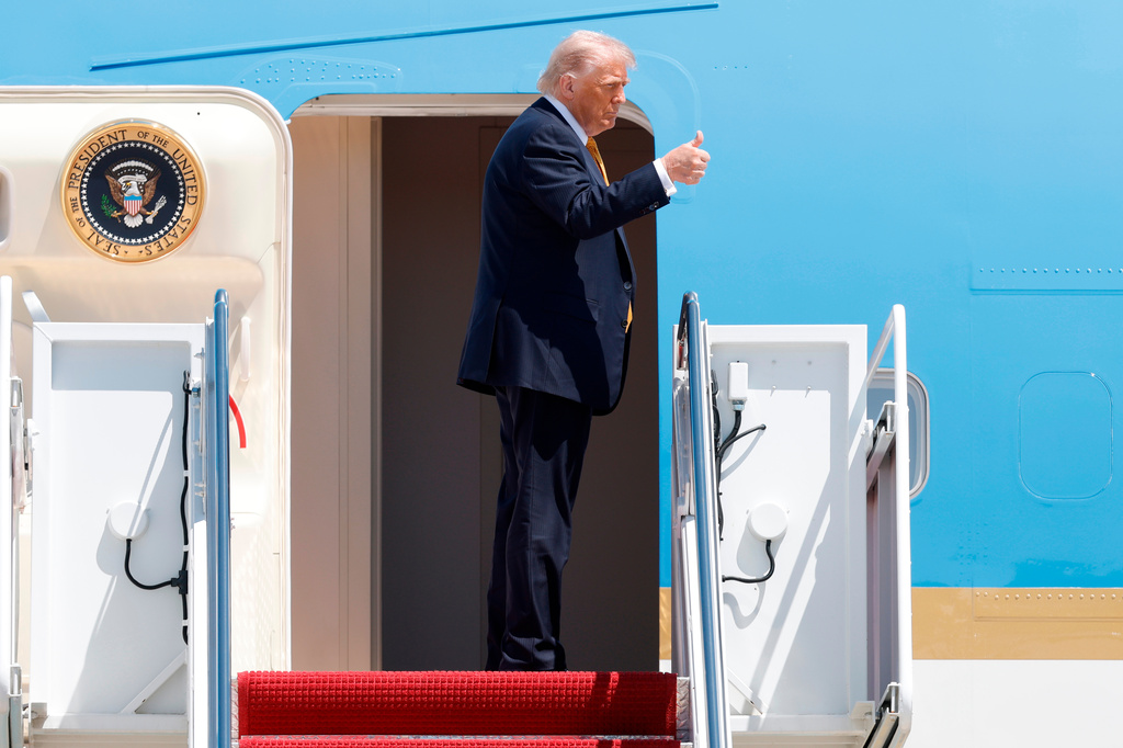 President Donald Trump gestures from the stairs of Air Force One as he boards upon his arrival at Joint Base Andrews, Md., Tuesday, May 12, 2026, for a trip to China to meet President Xi Jinping. (AP Photo/Luis M. Alvarez)