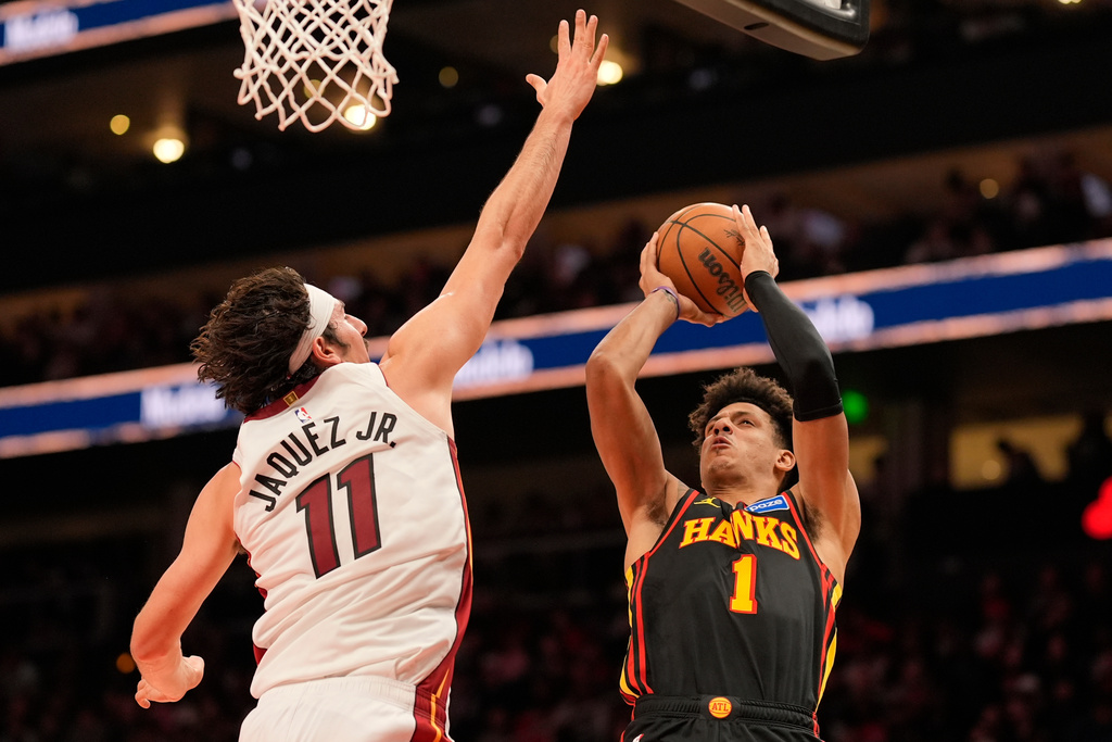Atlanta Hawks forward Jalen Johnson (1) shoots against Miami Heat forward Jaime Jaquez Jr. (11) during the first half of an NBA basketball game, Friday, Dec. 26, 2025, in Atlanta. (AP Photo/Mike Stewart)