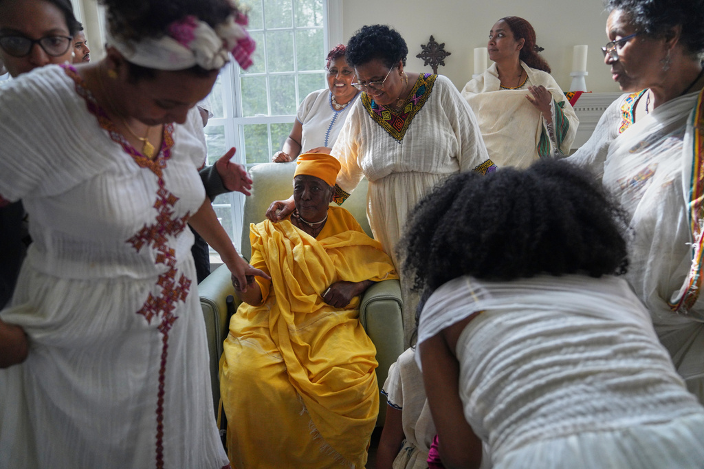 The Tekola family gathers for a feast to celebrate Easter, or Fasika in Amharic, and break their 55-day fasting period, Sunday, April 12, 2026, in Triangle, Va. (AP Photo/Jessie Wardarski)