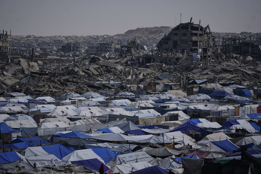 FILE - Tents sheltering displaced Palestinians stand amid the destruction left by the Israeli air and ground offensive in Gaza City Dec. 5, 2025. (AP Photo/Abdel Kareem Hana, File)