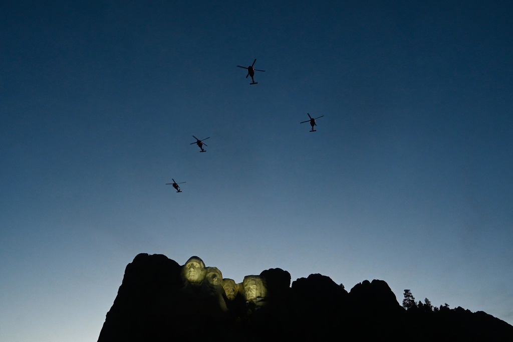 FILE - UH-60 Black Hawk helicopters perform a flyover as Interior Secretary Doug Burgum speaks before President Donald Trump at Mount Rushmore National Memorial, July 3, 2026, near Keystone, S.D. (AP Photo/Matt Gade, File)