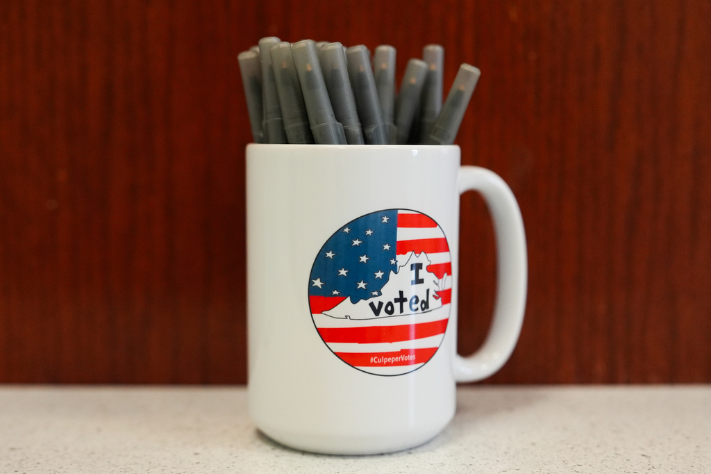A mug holds pens at the Culpeper County Voter Registration office during the early voting period in the Virginia redistricting referendum, Friday, April 3, 2026, in Culpeper, Va. (AP Photo/Julia Demaree Nikhinson)