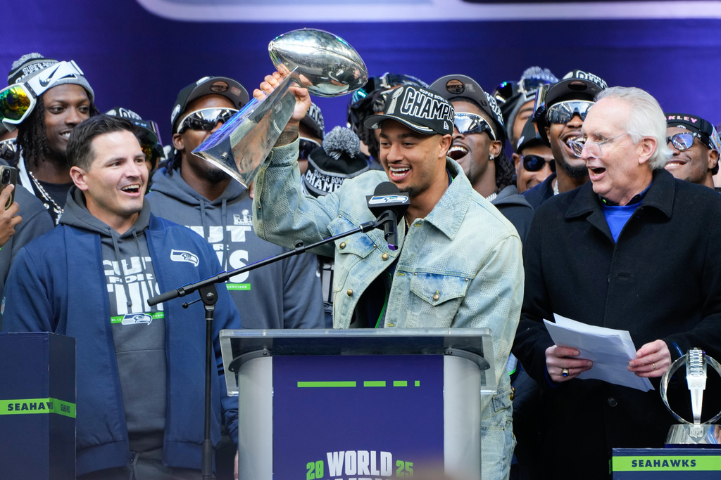 FILE - Seattle Seahawks wide receiver Jaxon Smith-Njigba holds the Lombardi Trophy during the team's NFL football Super Bowl 60 celebration at Lumen Field, Feb. 11, 2026, in Seattle. (AP Photo/Stephen Brashear, File)