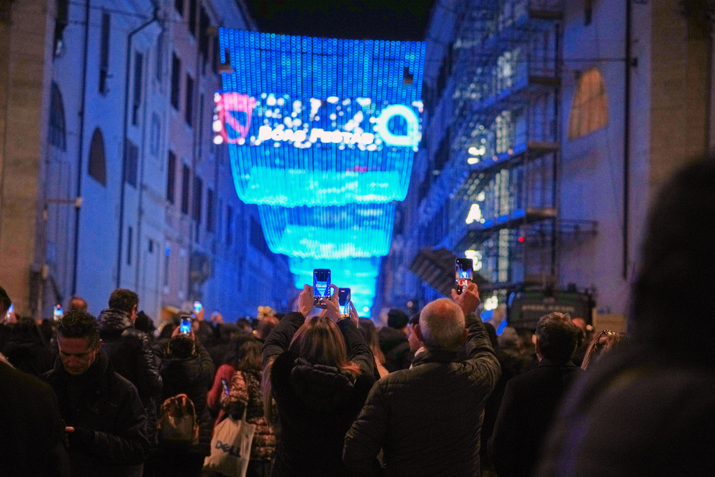 People photograph Christmas lights in Rome, Monday, Dec. 8, 2025. (AP Photo/Andrew Medichini)