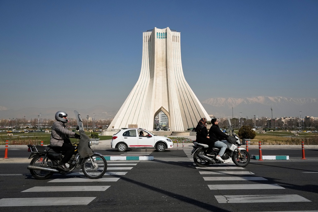 Vehicles drive by the Azadi (Freedom) monument in Tehran, Iran, Sunday, Feb. 22, 2026.(AP Photo/Vahid Salemi)