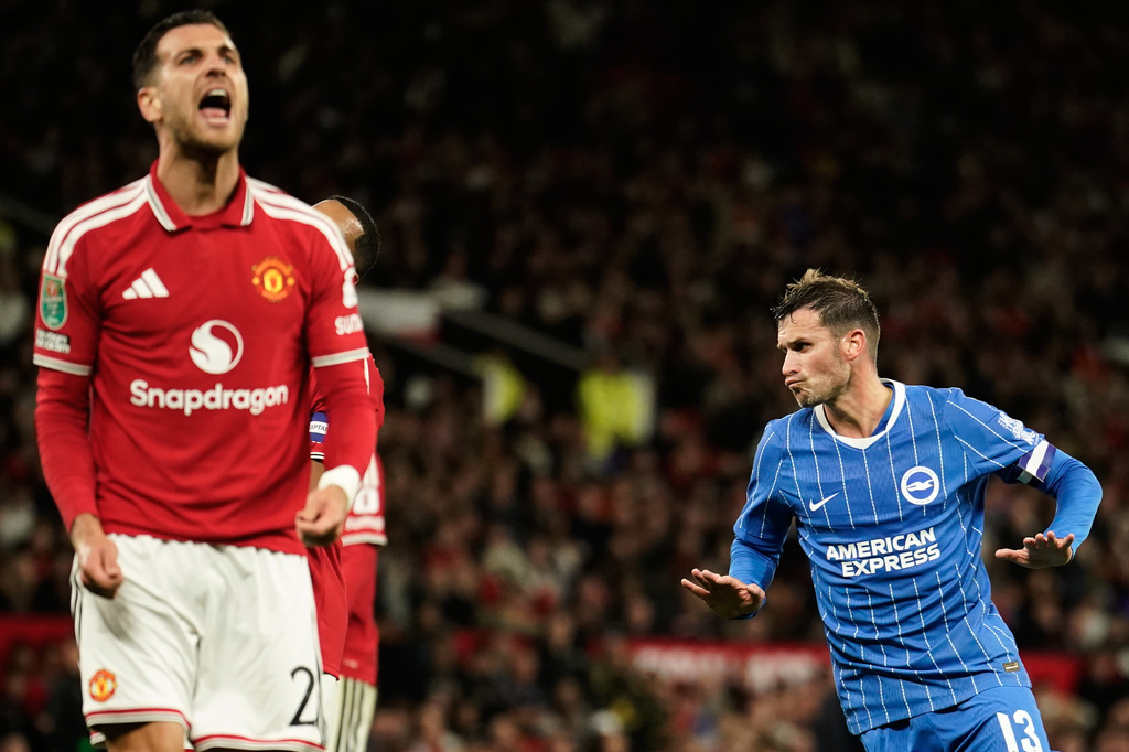 Brighton's Pascal Gross, right, celebrates after scoring his side's second goal during the English League Cup third round soccer match between Manchester United and Brighton and Hove Albion in Manchester, England, Wednesday, Sept. 16, 2026. (AP Photo/Dave Thompson)