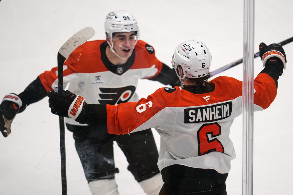 Philadelphia Flyers' Travis Sanheim (6) celebrates with Porter Martone (94) after scoring during the third period of Game 1 in the first round of the NHL Stanley Cup playoffs against the Pittsburgh Penguins in Pittsburgh, Saturday, April 18, 2026. (AP Photo/Gene J. Puskar)