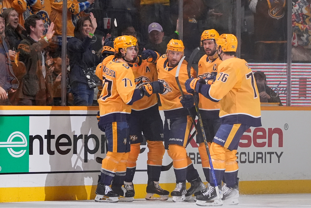 Nashville Predators right wing Luke Evangelista (77) celebrates his goal with teammates during the first period of an NHL hockey game against the San Jose Sharks, Tuesday, March 24, 2026, in Nashville, Tenn. (AP Photo/George Walker IV)