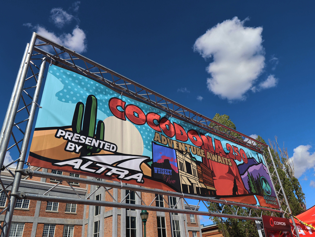 A banner for the Cocodona 250 ultramarathon hangs in downtown Flagstaff, Ariz., on Wednesday, May 6, 2026. (AP Photo/Cheyanne Mumphrey)