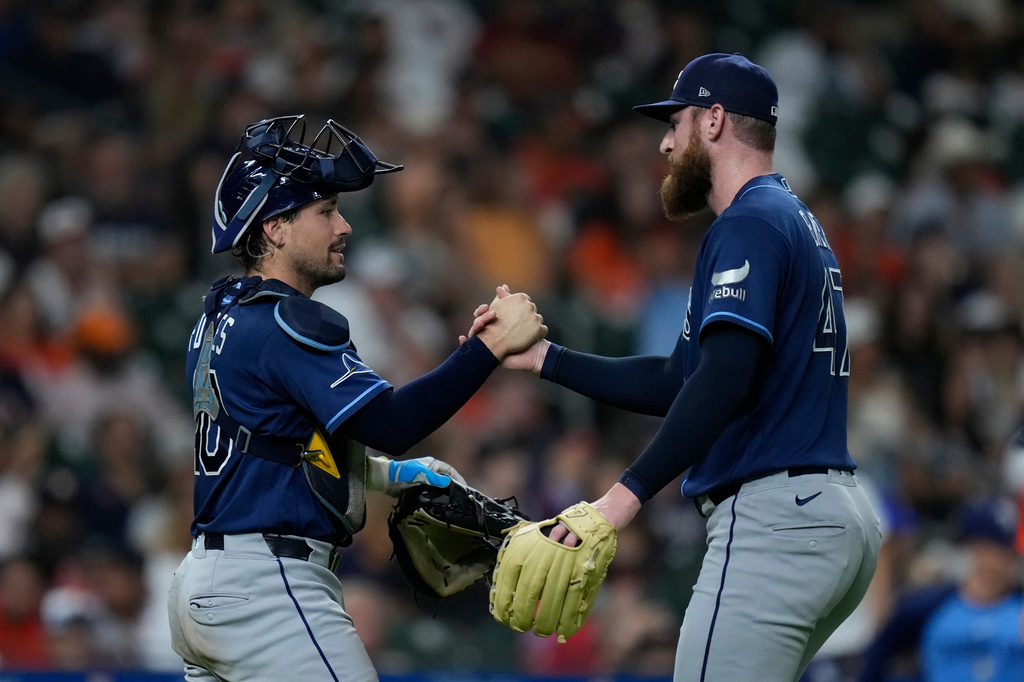 Tampa Bay Rays catcher Nick Fortes and pitcher Bryan Baker celebrate after a baseball game against the Houston Astros, Friday, July 3, 2026, in Houston. (AP Photo/Kevin M. Cox)