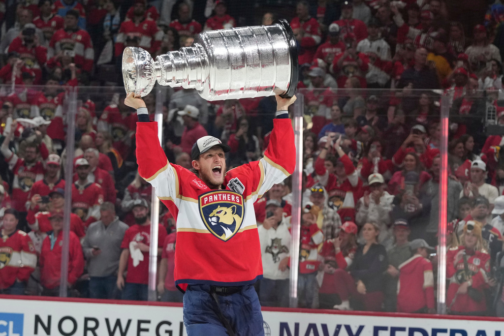 FILE - Florida Panthers center Eetu Luostarinen raises the Stanley Cup trophy after defeating the Edmonton Oilers in Game 6 of the NHL hockey Stanley Cup Final June 17, 2025, in Sunrise, Fla. (AP Photo/Lynne Sladky, File)