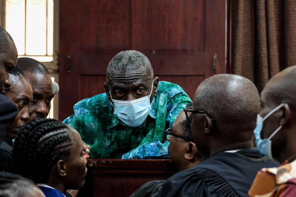 Uganda's veteran opposition leader Kizza Besigye, and his aides seen at High Court, in Kampala, Uganda, Monday, Dec. 29, 2025. (AP Photo/Hajarah Nalwadda)