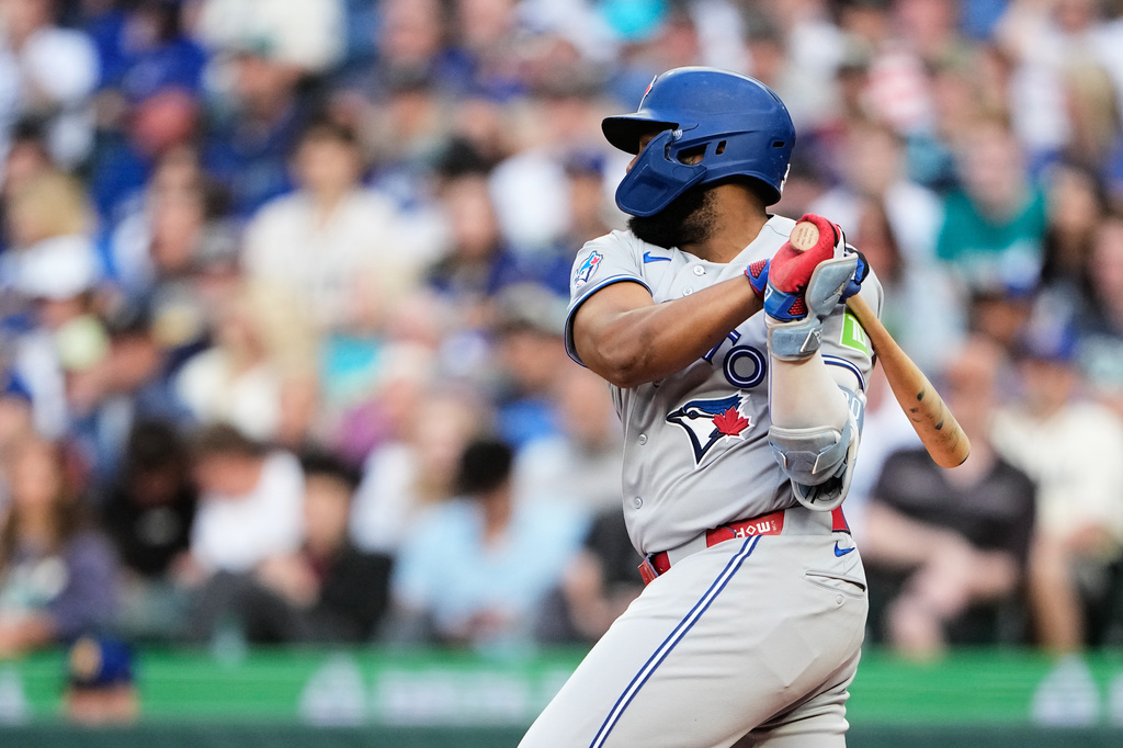 Toronto Blue Jays' Vladimir Guerrero Jr. hits an RBI single to score Andrés Giménez against the Seattle Mariners during the third inning of a baseball game, Friday, July 3, 2026, in Seattle. (AP Photo/Lindsey Wasson)