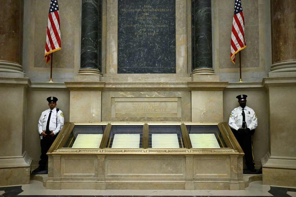 Two guards oversee the United States Constitution at the National Archives Thursday, Jan. 29, 2026, in Washington. (AP Photo/John McDonnell)
