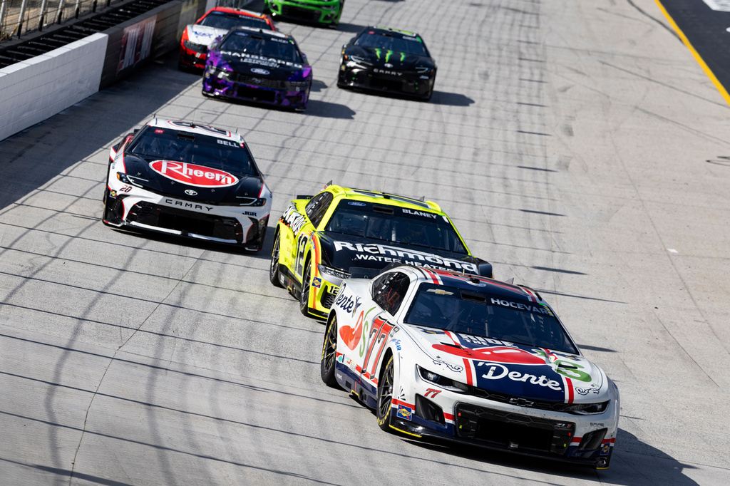 FILE - Carson Hocevar (77) leads Ryan Blaney (12), and Christopher Bell (20) Riley Herbst (35) during a NASCAR Cup Series auto race April 13, 2025, in Bristol, Tenn. (AP Photo/Wade Payne, File)